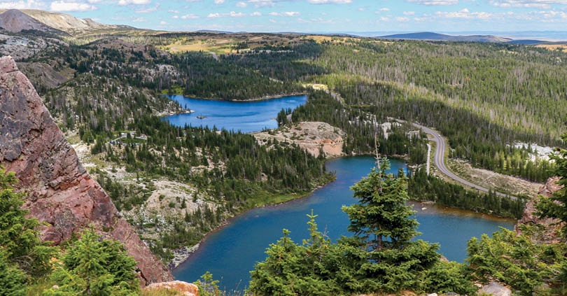 A beautiful view of a lake surrounded by mountains and trees. AI generated content